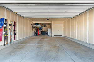 Garage featuring white refrigerator