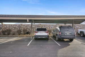 View of vehicle parking featuring a carport