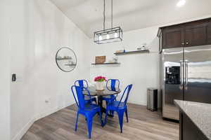 Dining space with light hardwood / wood-style flooring