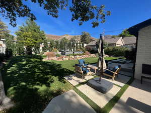 View of yard featuring a mountain view and a patio area