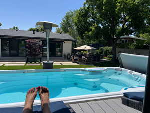 View of swimming pool with a deck