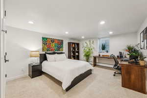 Carpeted bedroom with baseboard heating