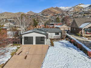 View of front facade with a mountain view and a garage