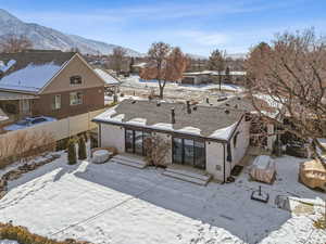 Snow covered house with a mountain view