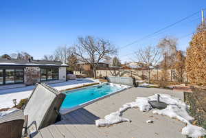 View of pool featuring a wooden deck