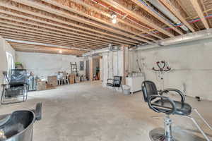 Basement featuring electric panel and washer / clothes dryer