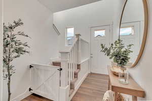 Foyer entrance with hardwood / wood-style floors