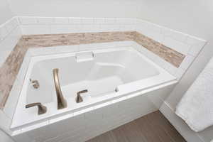 Bathroom featuring tiled bath