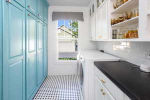 Laundry room with cabinets and washer and dryer