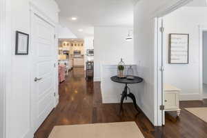 Hall with dark wood flooring