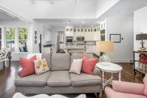 Living room featuring dark wood  flooring and sink