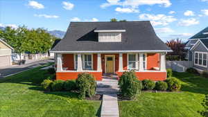 Bungalow-style house with a front lawn and a porch