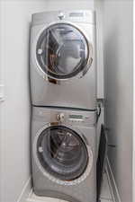 Laundry area with stacked washer and clothes dryer