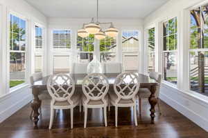 Sunroom / solarium featuring a chandelier and a healthy amount of sunlight