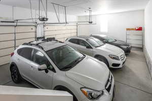 3 car garage featuring a garage door opener