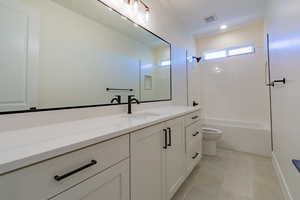 Full bathroom with shower / bathtub combination, tile patterned floors, toilet, and vanity