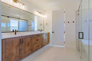 Bathroom featuring vanity, walk in shower, and tile patterned floors