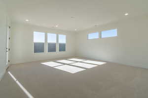 Unfurnished room featuring light colored carpet