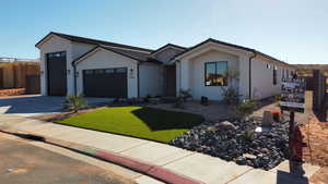 Ranch-style house with a garage and a front lawn