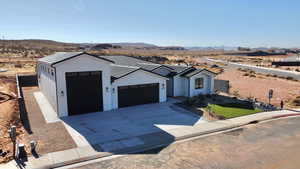 View of front of home featuring a garage and a mountain view