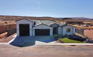 View of front of house with a garage and a mountain view