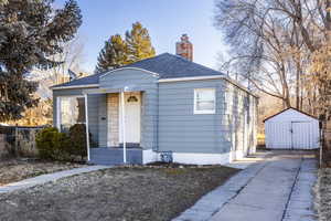 Bungalow-style home featuring a storage shed