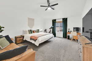 Carpeted bedroom featuring ceiling fan and lofted ceiling