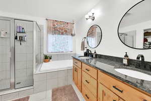 Bathroom featuring vanity, separate shower and tub, and tile patterned flooring