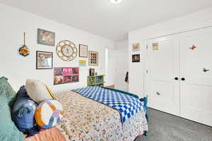 Bedroom featuring carpet floors and a closet