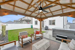 View of patio / terrace featuring ceiling fan, a gazebo, a hot tub, and an outdoor living space