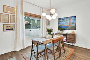 Dining room featuring dark hardwood / wood-style floors and a notable chandelier