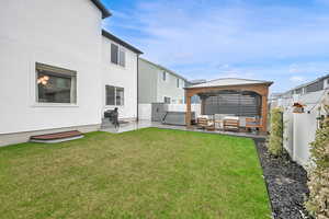 View of yard featuring a gazebo, a hot tub, an outdoor living space, and a patio