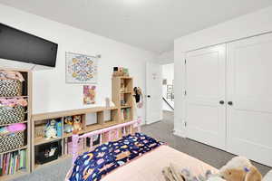 Bedroom featuring carpet and a closet