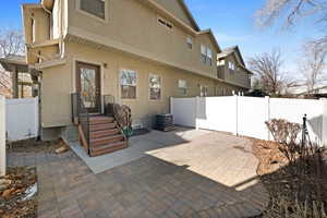 Rear view of property featuring cooling unit and a patio