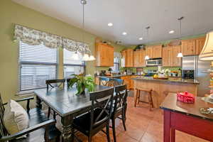 Tiled dining room featuring sink