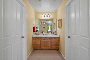 Bathroom featuring vanity and a textured ceiling