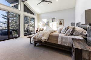 Bedroom featuring ceiling fan, carpet flooring, access to exterior, high vaulted ceiling, and beamed ceiling