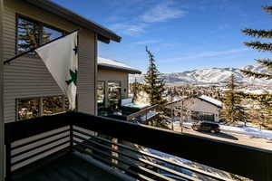 Snow covered back of property with a mountain view