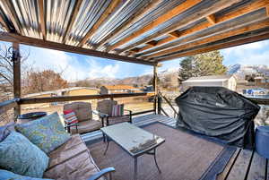 Wooden deck featuring a mountain view and outdoor lounge area