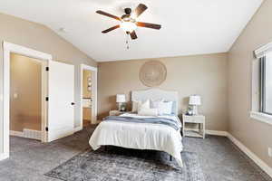 Carpeted bedroom featuring ceiling fan and lofted ceiling