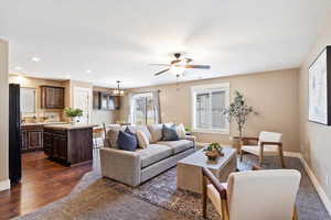 Living room featuring ceiling fan and dark hardwood / wood-style flooring