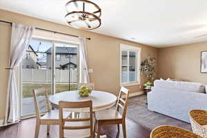 Dining area with dark hardwood / wood-style flooring