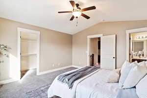 Carpeted bedroom featuring lofted ceiling, a closet, a spacious closet, and ceiling fan