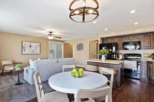 Dining area with dark hardwood / wood-style floors and ceiling fan