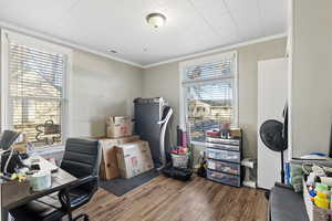 Office area featuring plenty of natural light, hardwood / wood-style floors, and ornamental molding