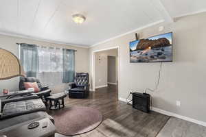 Living room featuring crown molding, hardwood / wood-style flooring, and beamed ceiling ADU