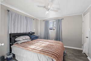 Bedroom featuring ceiling fan, crown molding, and dark wood-type flooring ADU