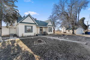 View of front of house with a garage and an outdoor structure