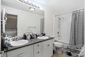 Full bathroom with tile patterned floors, shower / washtub combination, toilet, a textured ceiling, and vanity MAIN HOME