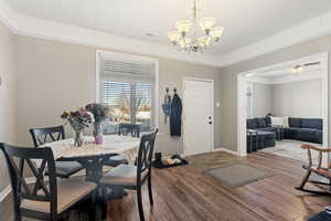 Dining room featuring hardwood / wood-style floors and an inviting chandelier MAIN MAIN HOME